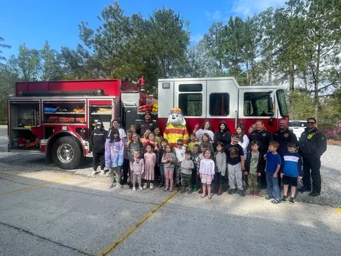 The whole school visiting with local firefighters and their fire truck