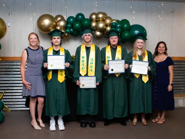 The graduating class in green caps and gowns holding their high school diplomas