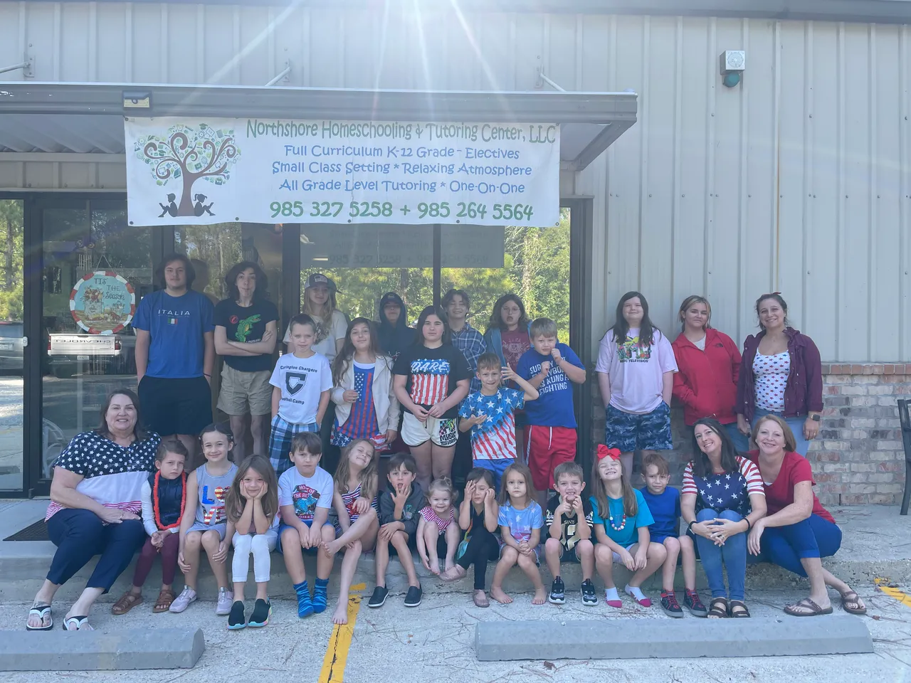 The whole school — students and teachers — in front of the Northshore HTC banner