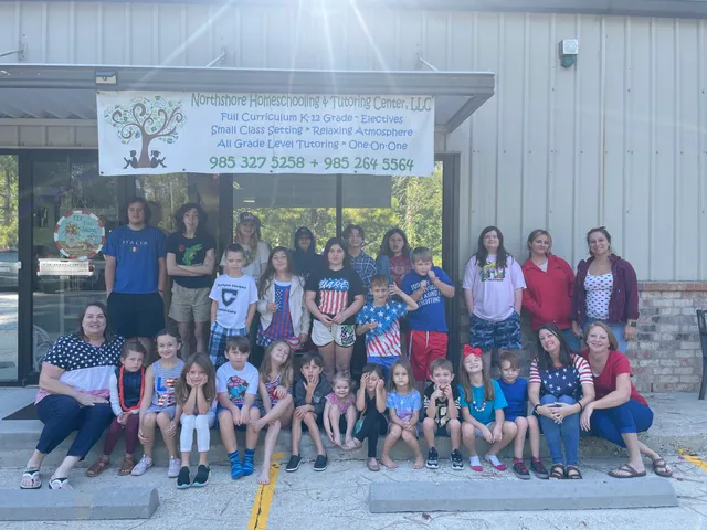 The whole school — students and teachers — in front of the Northshore HTC banner