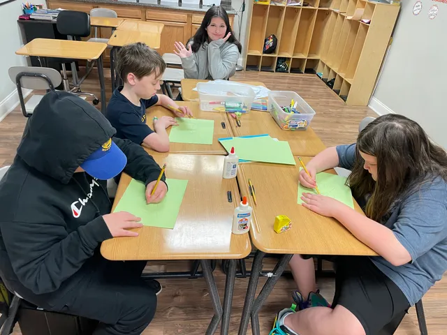 Students working quietly at their desks in a small NHTC classroom