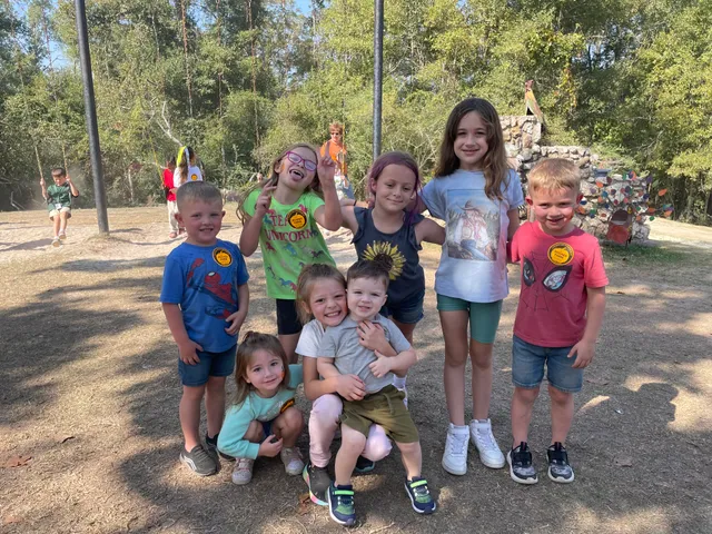 A happy group of students posing together on a park day field trip