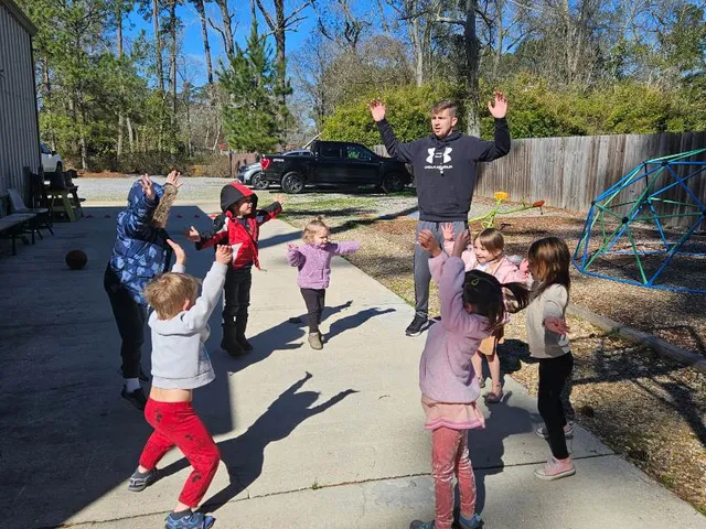 Children playing together outside at recess on a sunny day