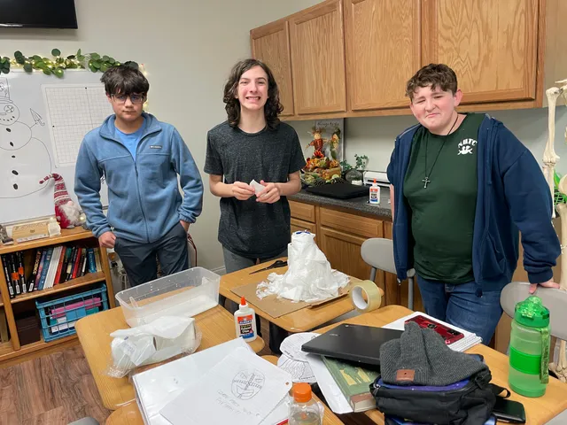 Three upper-grade students during a hands-on classroom project